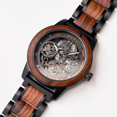 Wooden watch with black metal accents on a white background